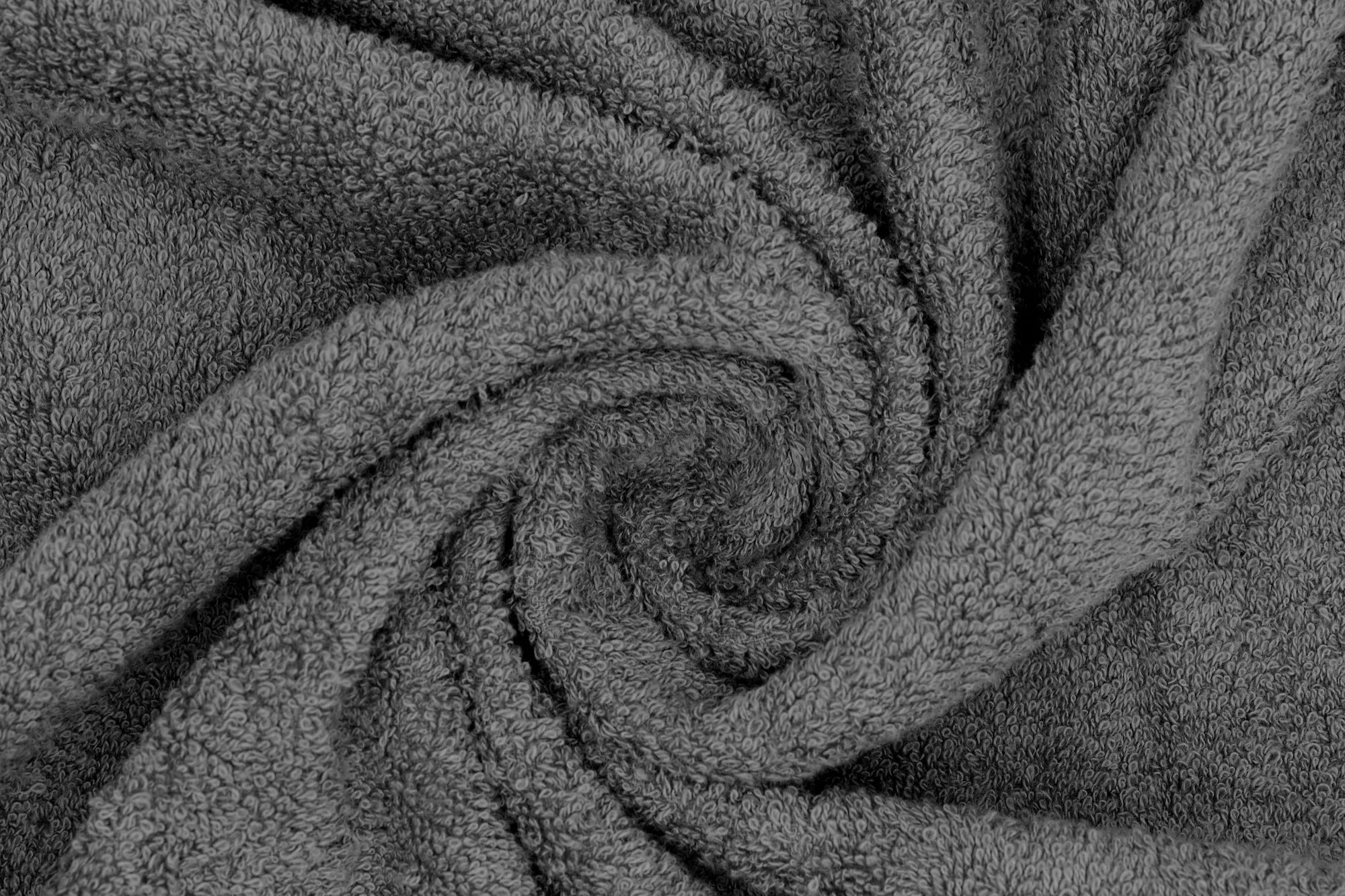 Close-up of a soft, grey, textured towel in a spiral pattern.